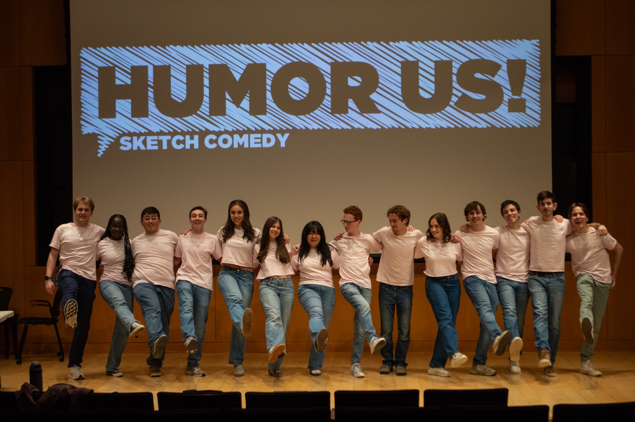 HumorUs cast on stage kicking in sync